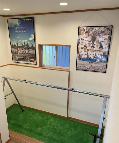 a room with two posters on the wall and a green carpet at Guest house HaDuNo - Vacation STAY 85297v in Shingu