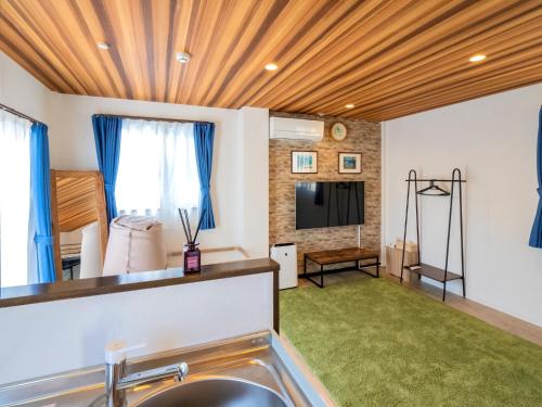 a living room with a sink and a television at Another sky - Vacation STAY 90163v in Miyazaki