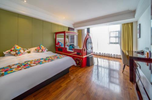 a bedroom with a large bed and a play room at Shanghai Dixuan Junlan Resort Hotel in Shanghai