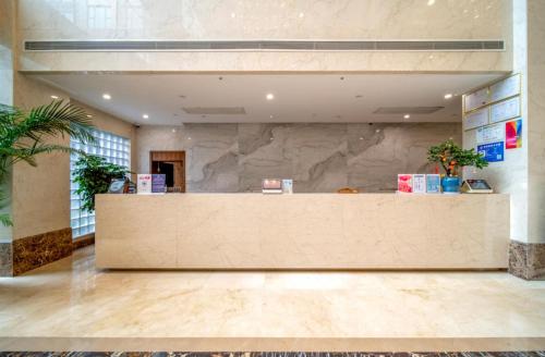 a lobby with a large reception desk in a building at Shanghai Dixuan Junlan Resort Hotel in Shanghai