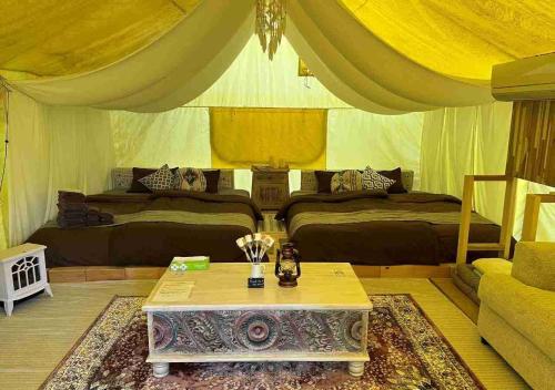 a tent bedroom with two beds and a table at Keisaji CAMP SITE - Vacation STAY 90073v in Ijinabaru
