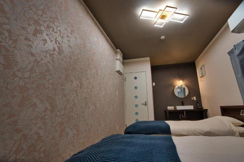 a bedroom with a bed and a wall at racine yakushima - Vacation STAY 86828v in Ambo