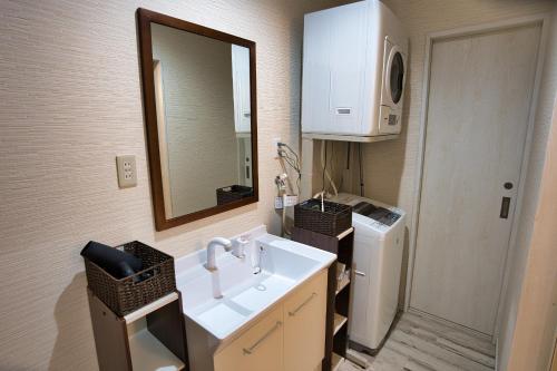 a bathroom with a sink and a mirror at racine yakushima - Vacation STAY 86828v in Ambo