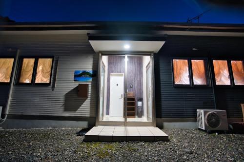 a front door of a house at night at racine yakushima - Vacation STAY 86828v in Ambo
