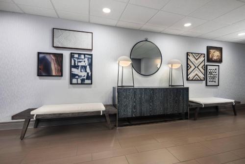 a dressing room with two benches and a mirror at Country Inn & Suites by Radisson Asheville Downtown Tunnel Road in Asheville