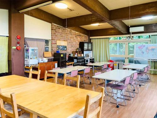 a classroom with tables and chairs in a room at Amanohashidate Youth Hostel - Vacation STAY 94802v in Miyazu