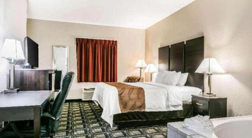 a hotel room with a bed and a sink at Suburban Studios Mason Hwy 42 in Mason