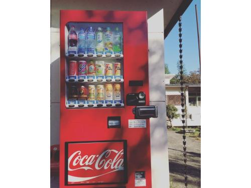 a cocacola vending machine with bottles of soda at Amanohashidate Youth Hostel - Vacation STAY 94808v in Miyazu