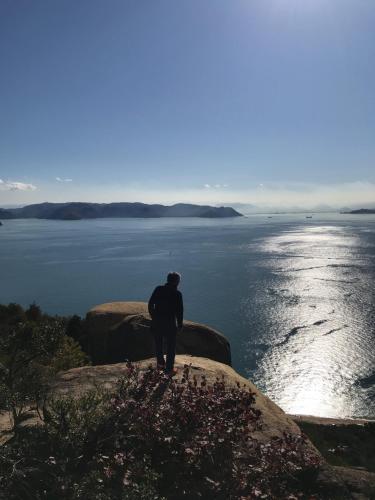 a man standing on a rock overlooking the ocean at oyadoyadokari - Vacation STAY 08483v in Okayama