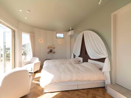 a bedroom with a bed with a white canopy at HV hygge setouchi - Vacation STAY 09912v in Yamaguchi
