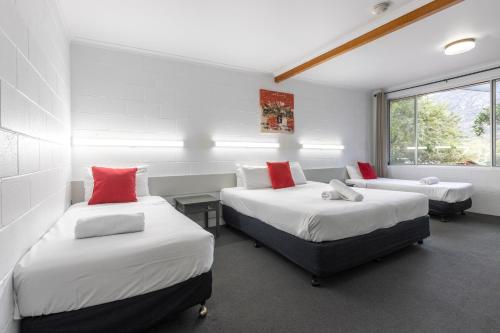 a room with two beds and a window at The Grampians Motel in Halls Gap