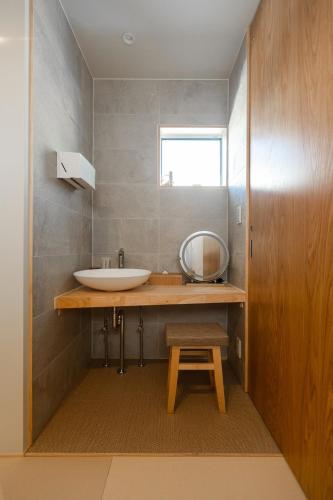 a bathroom with a sink and a mirror on a counter at ZIPANG - Vacation STAY 02088v in Matsue