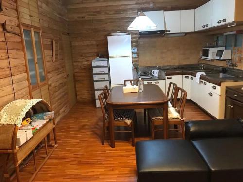 a kitchen with a table and chairs in a room at Mori no Komei campsite - Vacation STAY 04499v in Kita-karuizawa