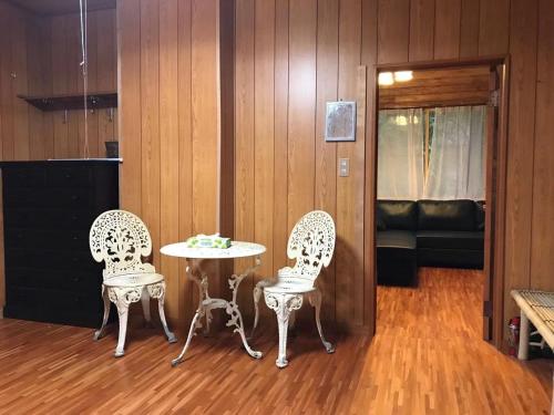 two chairs and a table in a room at Mori no Komei campsite - Vacation STAY 04499v in Kita-karuizawa