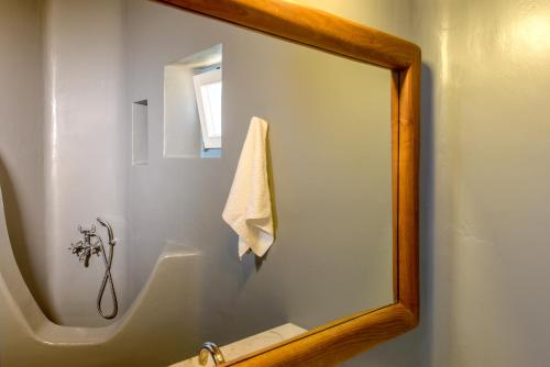 a mirror in a bathroom with a sink at Sunset Villa in Houlakia