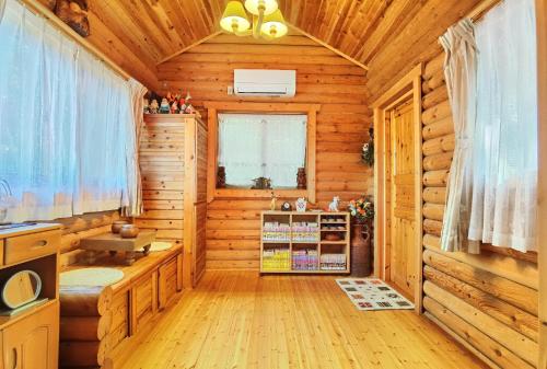 a log cabin with a kitchen and a living room at Garden view Japanese style room - Vacation STAY 15090 in Mimasaka