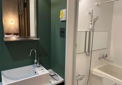 a bathroom with a white sink and a mirror at COFFEE HOTEL Soundwave - Vacation STAY 17815v in Fujisawa