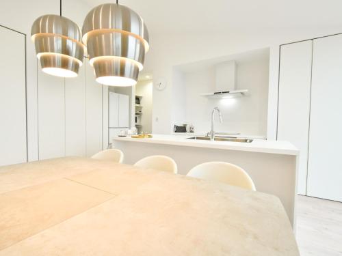 a kitchen and dining room with a large wooden table and chairs at Seagull east coast Awaji - Vacation STAY 21943v in Awaji