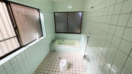 a bathroom with a bath tub and a sink at Shimanto Yamamizuki - Vacation STAY 36946v in Shimanto