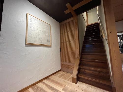 a staircase in a room with a picture on the wall at CalmbaseRIVER - Vacation STAY 22009v in Numazu