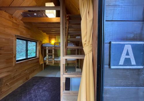 a room with bunk beds in a cabin with a door at NAKADAKI ART VILLAGE - Vacation STAY 41951v in Shiigi
