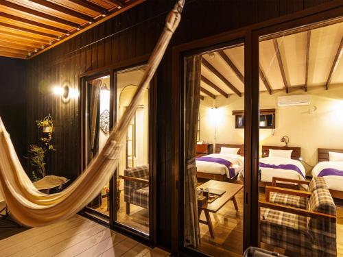 a room with two beds and a hammock in it at Sense of wonder Yufudake Sanroku Glamping Resort - Vacation STAY 41963v in Yufuin