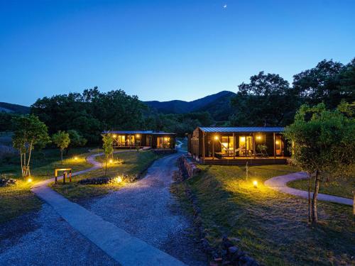 a cabin in the woods at night with lights at Sense of wonder Yufudake Sanroku Glamping Resort - Vacation STAY 41962v in Yufuin
