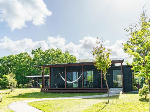 a modern house in a park with trees at Sense of wonder Yufudake Sanroku Glamping Resort - Vacation STAY 41962v in Yufuin