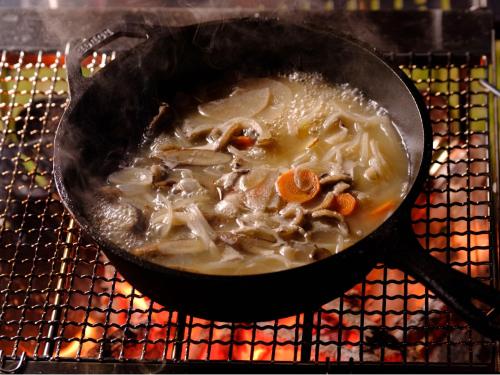 a pan filled with soup on a grill at Sense of wonder Yufudake Sanroku Glamping Resort - Vacation STAY 41962v in Yufuin