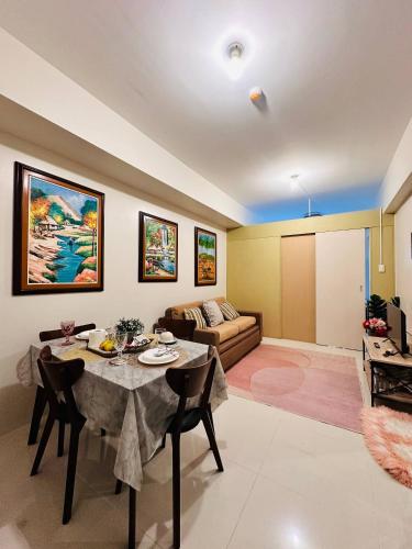 a living room with a table and a couch at Recharge Chamber Simoy in Kaybagal