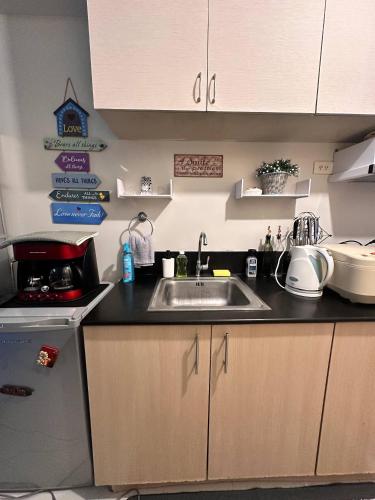 a kitchen with a sink and a counter top at Recharge Chamber Simoy in Kaybagal