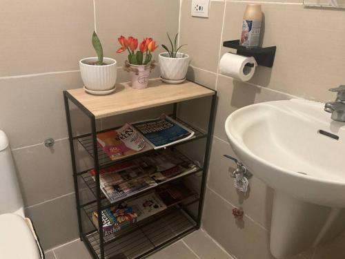 a bathroom with a shelf next to a sink at Recharge Chamber Simoy in Kaybagal