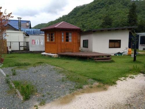 a small cabin with a wooden deck in a yard at Ayu no Sato Park Campsite - Vacation STAY 42154v in Shōbara