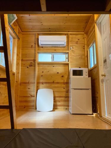 a small kitchen with a stove and a refrigerator at CAMP GO4SURF - Vacation STAY 42070v in Moriya