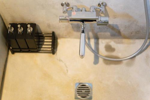 a sink with a hose hooked up to a shower at the terrace sumoto - Vacation STAY 24588v in Sumoto