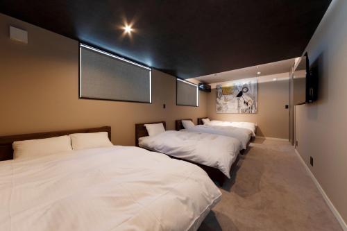 a row of three beds in a room at GranTerace Sun - Vacation STAY 15256 in Numazu