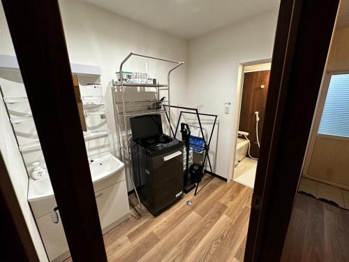a room with a room with a television and a room with a room at Tsunageru Aomori Yasukata - Vacation STAY 25824v in Aomori