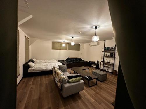 a living room with a couch and a table at Tsunageru Aomori Yasukata - Vacation STAY 25824v in Aomori