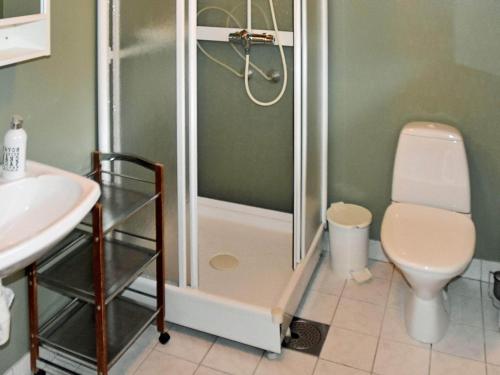 a bathroom with a shower and a toilet and a sink at 4 person holiday home in Måndalen-By Traum in Sæbø