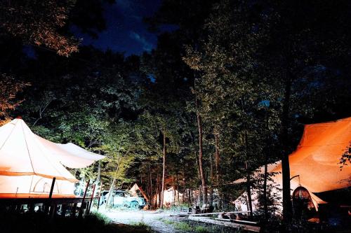 a tent and a table and some trees at night at Glamping Azumino BASE Polecamp - Vacation STAY 08105v in Azumino