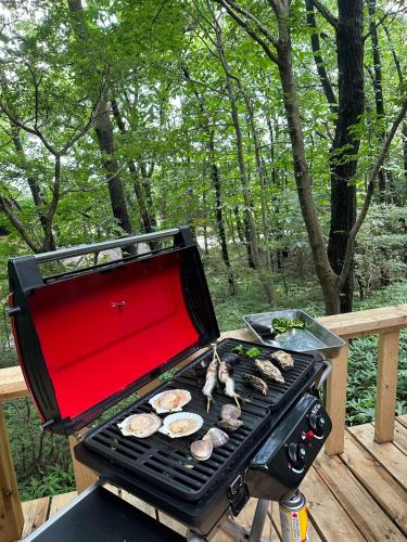 a grill with hamburgers and mushrooms on it at MYKARIN - Vacation STAY 39160v in Nasu-yumoto