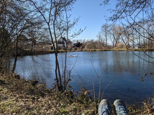 a person with their feet up next to a river at Morscheid-Riedenburg Stay in Morbach