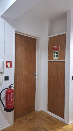 an empty room with a door and a fire extinguisher at Pescadores GuestHouse in Costa da Caparica