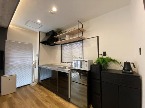 a small kitchen with a counter and a microwave at Frontier 1st Building - Vacation STAY 15474 in Kagoshima