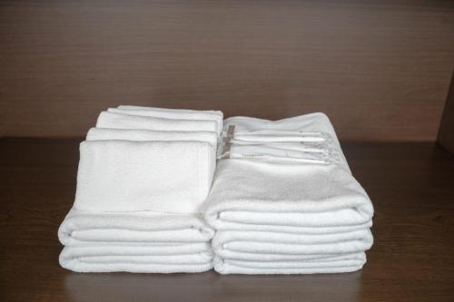 a stack of white towels sitting on a table at Twilight Hills - Vacation STAY 32702v in Motobu