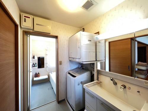 a small kitchen with a refrigerator and a sink at Inori Resort SORAKAZE - Vacation STAY 49443v in Shushi