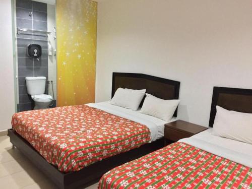 Кровать или кровати в номере All Star Hotel Melaka