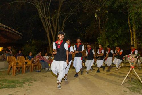 a group of people are dancing in aestival at Green Mansions Jungle Resort in Sauraha
