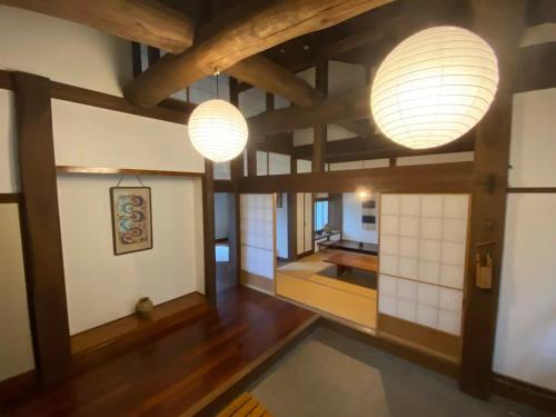 a living room with two lights and wooden floors at Nanakuniyama Minka - Vacation STAY 37250v in Isumi