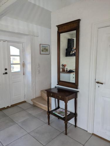 a mirror sitting on a table in a room at Strandhuset in Agger